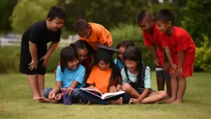021033000 1683087424 group children lying reading grass field